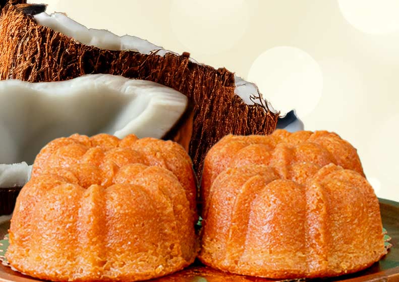 Two bundt cakes with a halved coconut on a light background