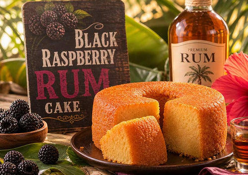 Black Raspberry Rum Cake with a bottle of rum and blackberries on a decorative background