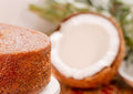 Coconut rum cake with a coconut shell on a blurred background