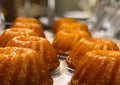 Row of small Bundt cakes on a metal tray with a blurred background