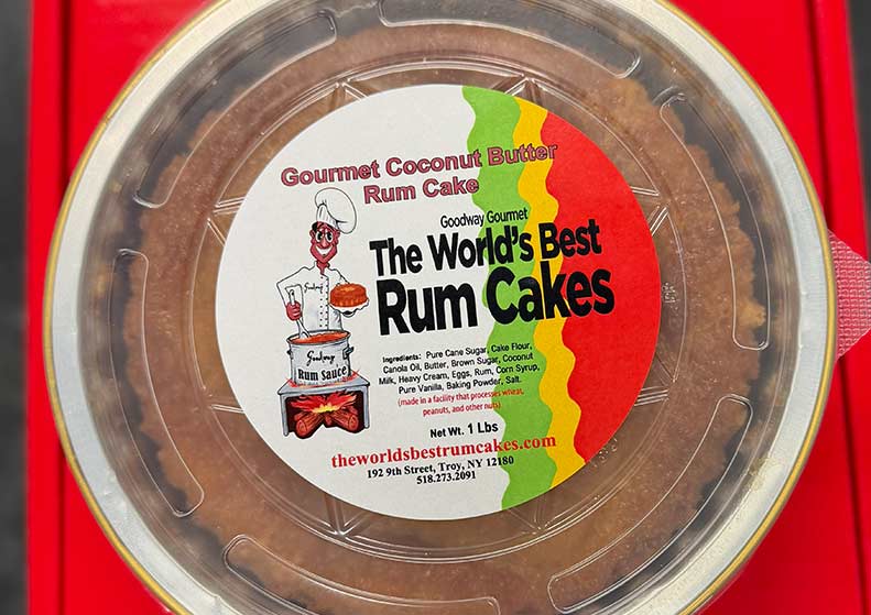 Gourmet coconut butter rum cake packaging with a label on a red background