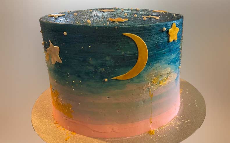 Cake decorated with a moon and stars on a neutral background