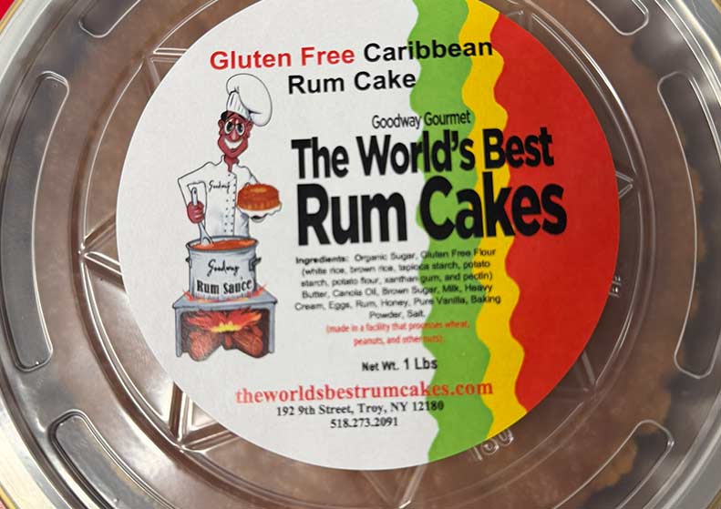 Packaged rum cake with colorful label featuring text and graphics.
