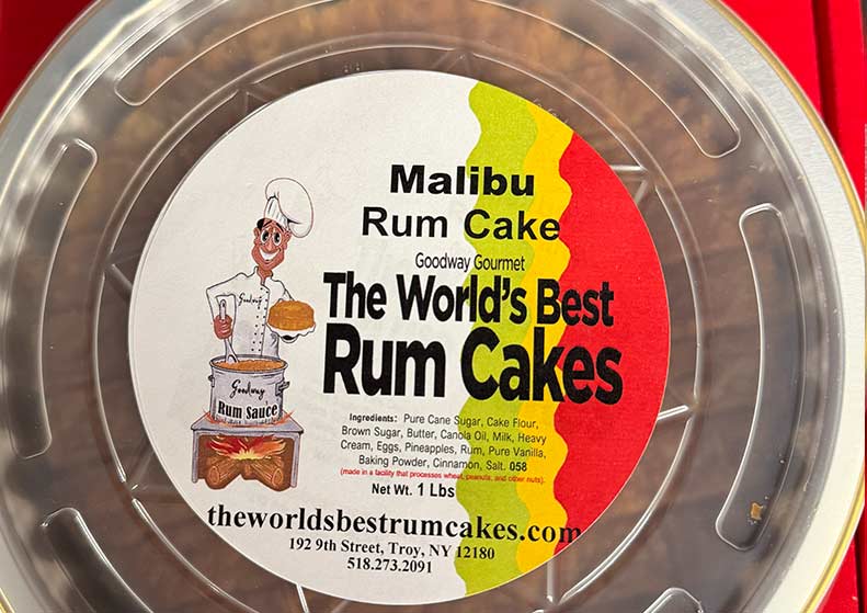 Malibu Rum Cake packaging with a cartoon chef and colorful label on a red background