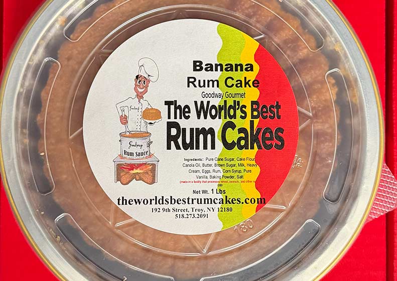 Banana Rum Cake packaging with a cartoon chef and cake illustration on a red background