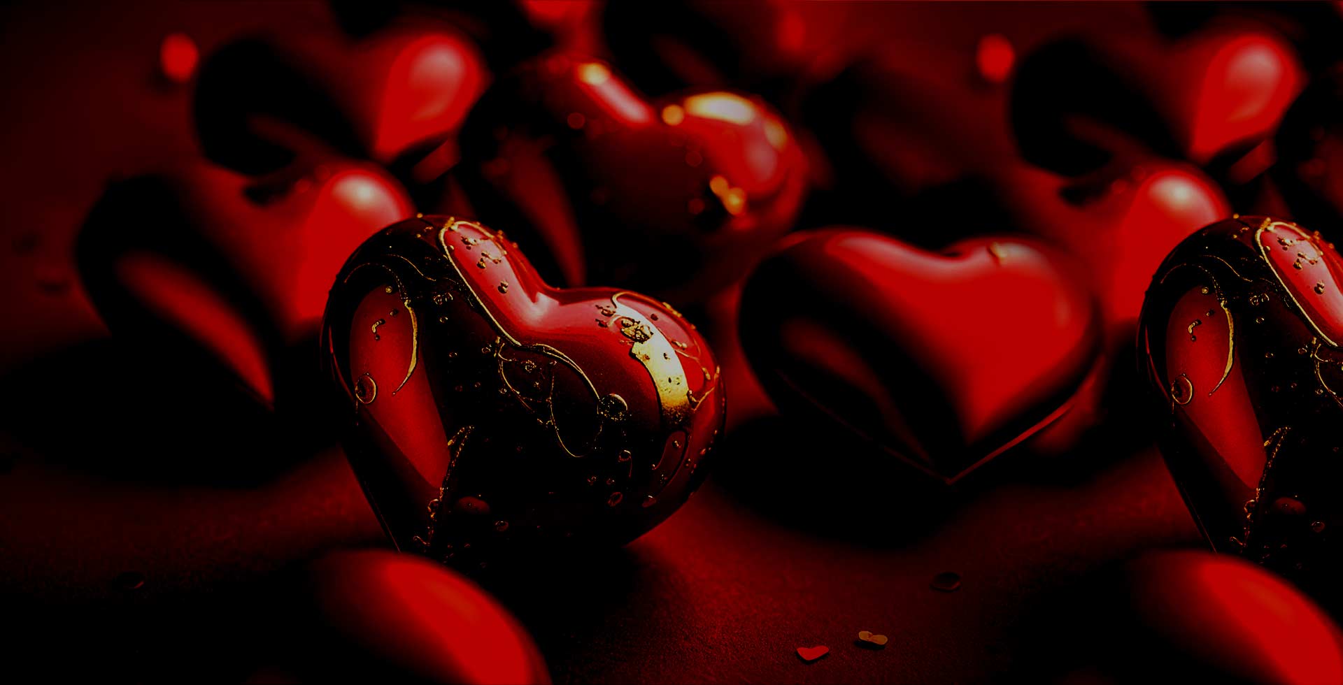 Heart-shaped chocolate candies on a dark background